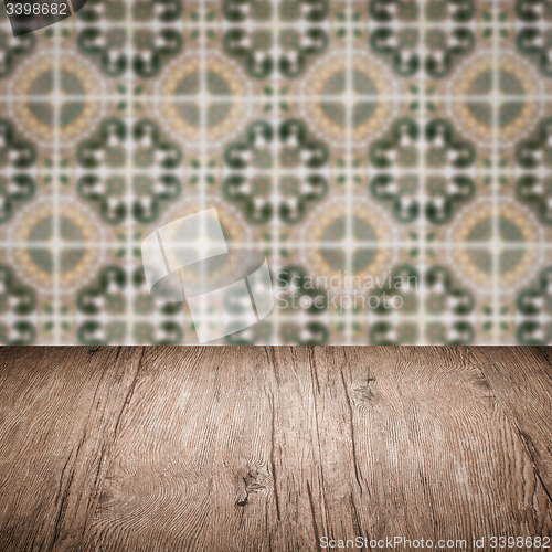 Image of Wood table top and blur vintage ceramic tile pattern wall