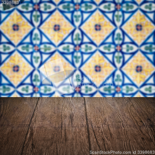 Image of Wood table top and blur vintage ceramic tile pattern wall