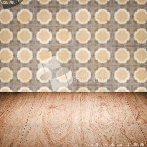 Image of Wood table top and blur vintage ceramic tile pattern wall