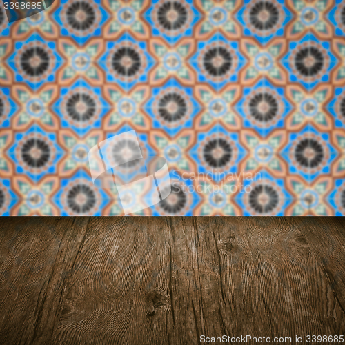 Image of Wood table top and blur vintage ceramic tile pattern wall