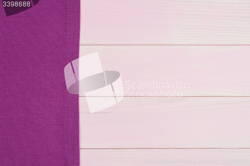 Image of Purple towel over wooden table