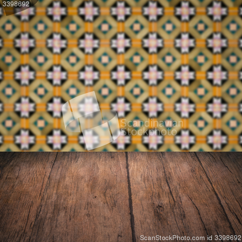 Image of Wood table top and blur vintage ceramic tile pattern wall