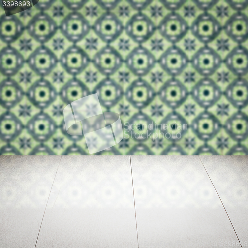 Image of Wood table top and blur vintage ceramic tile pattern wall