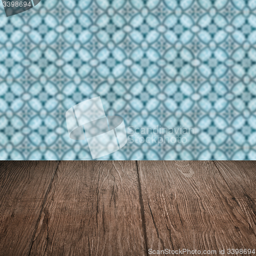 Image of Wood table top and blur vintage ceramic tile pattern wall