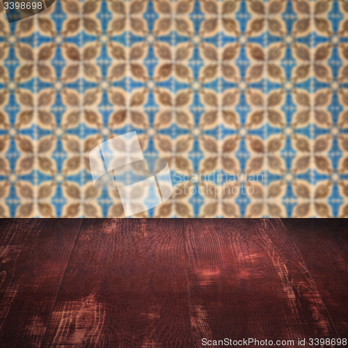 Image of Wood table top and blur vintage ceramic tile pattern wall
