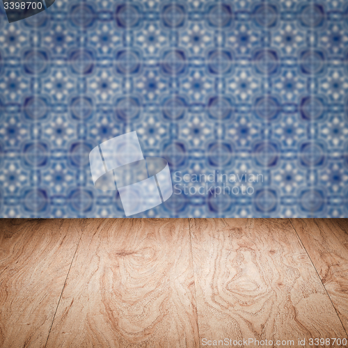 Image of Wood table top and blur vintage ceramic tile pattern wall