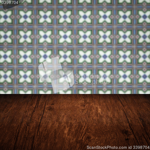 Image of Wood table top and blur vintage ceramic tile pattern wall