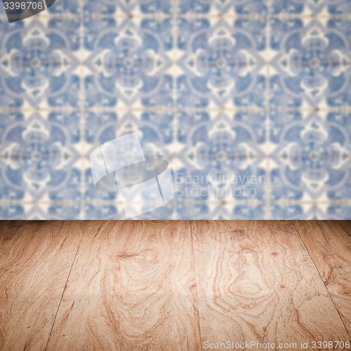 Image of Wood table top and blur vintage ceramic tile pattern wall