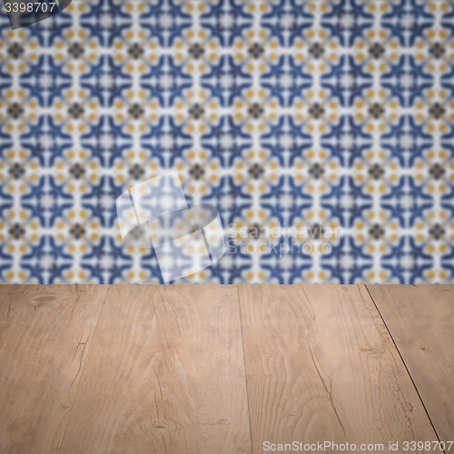 Image of Wood table top and blur vintage ceramic tile pattern wall