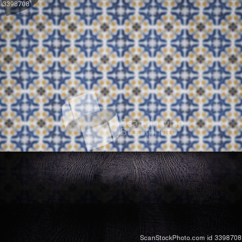 Image of Wood table top and blur vintage ceramic tile pattern wall