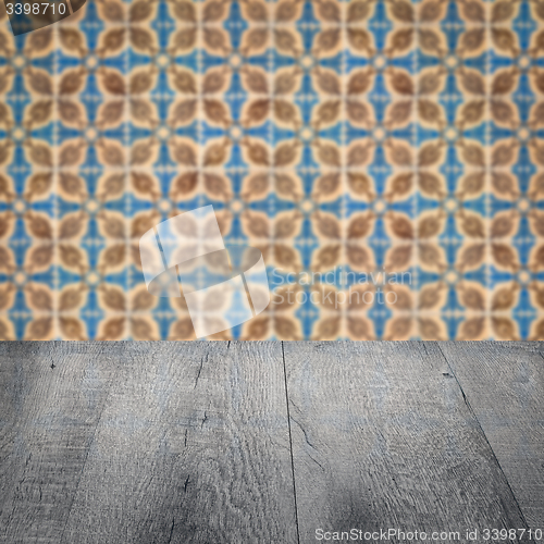 Image of Wood table top and blur vintage ceramic tile pattern wall