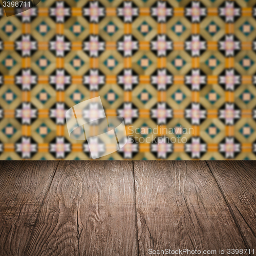 Image of Wood table top and blur vintage ceramic tile pattern wall