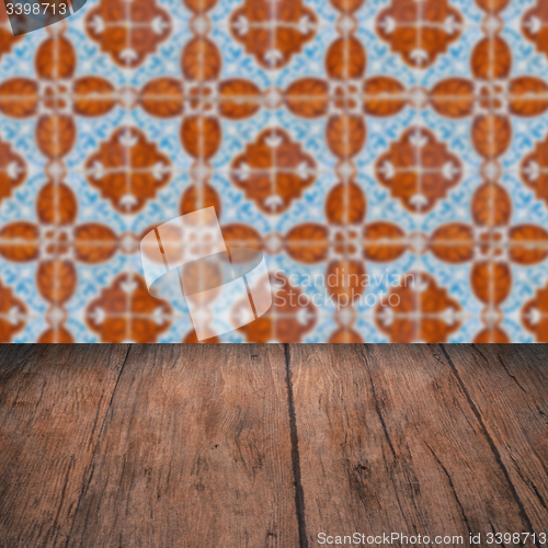 Image of Wood table top and blur vintage ceramic tile pattern wall