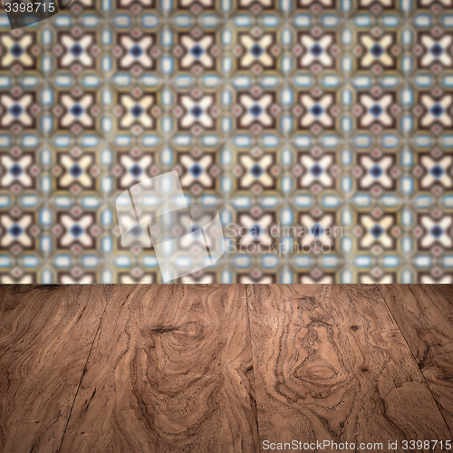 Image of Wood table top and blur vintage ceramic tile pattern wall