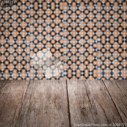 Image of Wood table top and blur vintage ceramic tile pattern wall