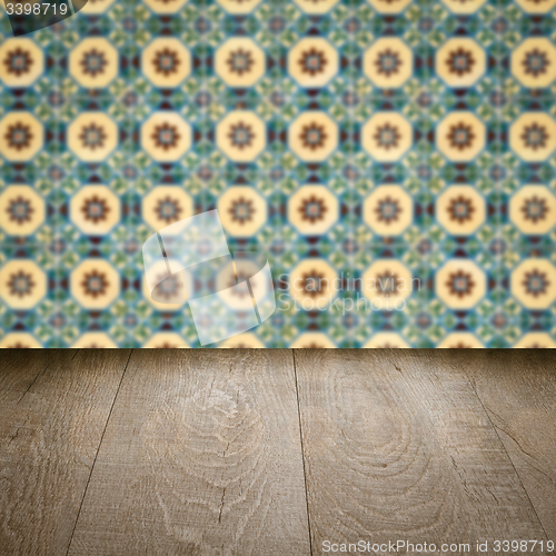 Image of Wood table top and blur vintage ceramic tile pattern wall