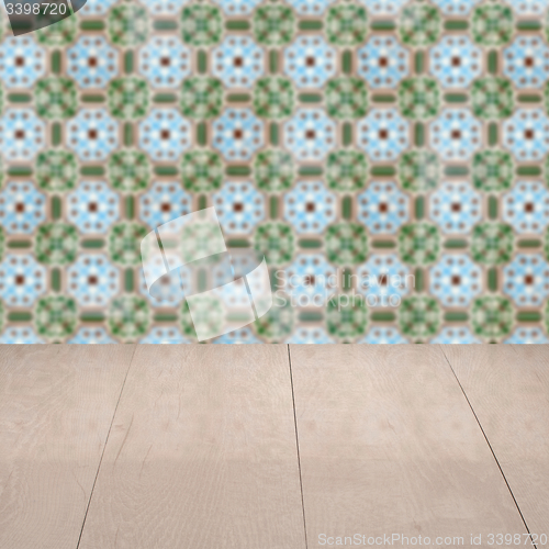 Image of Wood table top and blur vintage ceramic tile pattern wall