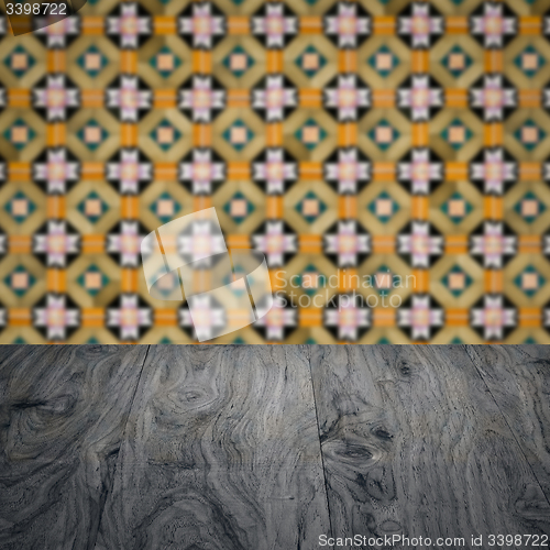 Image of Wood table top and blur vintage ceramic tile pattern wall