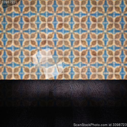 Image of Wood table top and blur vintage ceramic tile pattern wall
