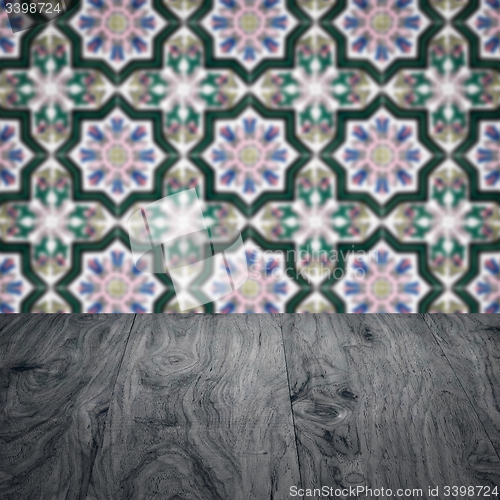 Image of Wood table top and blur vintage ceramic tile pattern wall