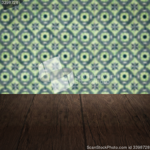 Image of Wood table top and blur vintage ceramic tile pattern wall