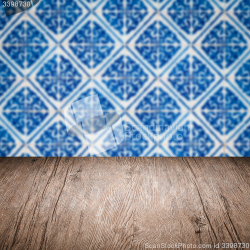 Image of Wood table top and blur vintage ceramic tile pattern wall