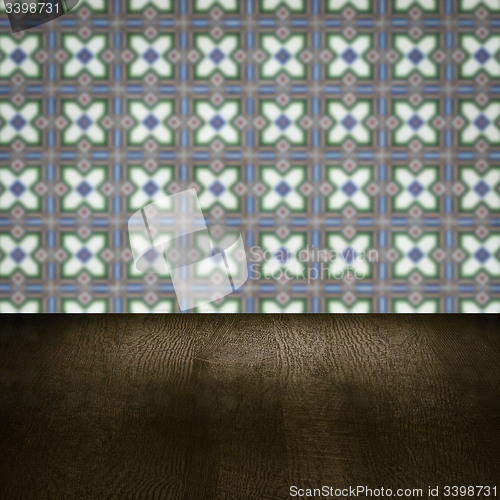 Image of Wood table top and blur vintage ceramic tile pattern wall
