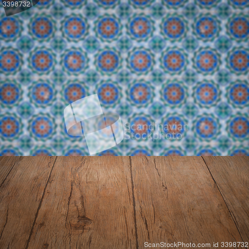 Image of Wood table top and blur vintage ceramic tile pattern wall
