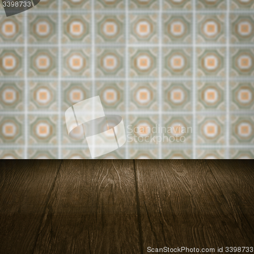 Image of Wood table top and blur vintage ceramic tile pattern wall