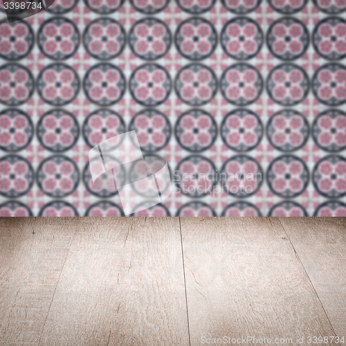 Image of Wood table top and blur vintage ceramic tile pattern wall