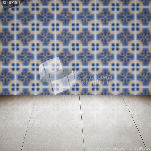 Image of Wood table top and blur vintage ceramic tile pattern wall