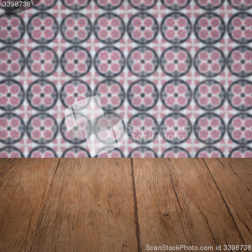 Image of Wood table top and blur vintage ceramic tile pattern wall