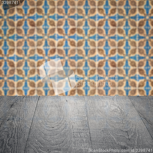 Image of Wood table top and blur vintage ceramic tile pattern wall