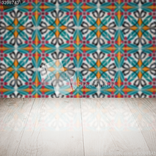 Image of Wood table top and blur vintage ceramic tile pattern wall