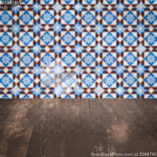 Image of Wood table top and blur vintage ceramic tile pattern wall