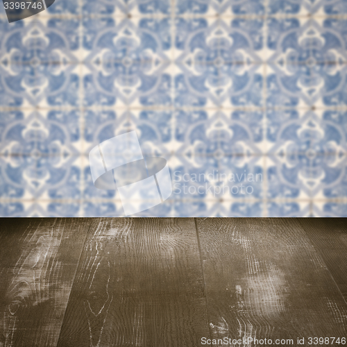 Image of Wood table top and blur vintage ceramic tile pattern wall
