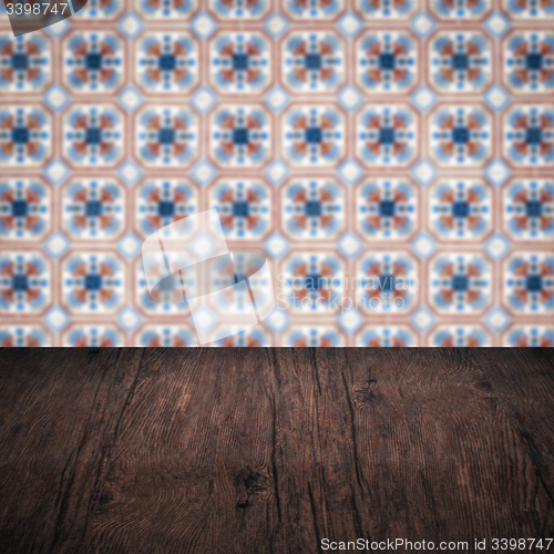 Image of Wood table top and blur vintage ceramic tile pattern wall