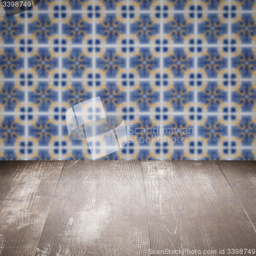 Image of Wood table top and blur vintage ceramic tile pattern wall