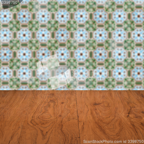 Image of Wood table top and blur vintage ceramic tile pattern wall