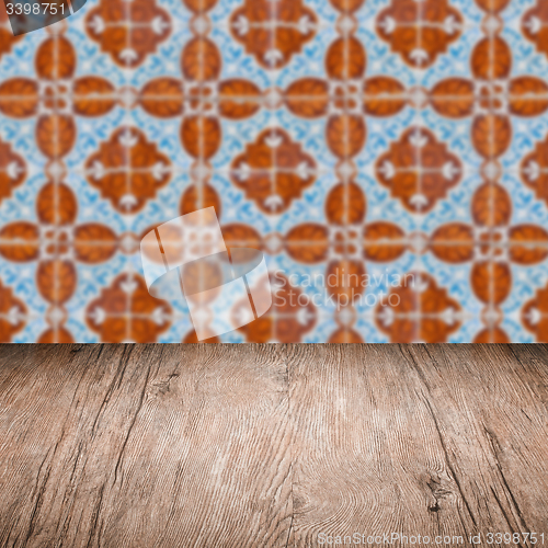 Image of Wood table top and blur vintage ceramic tile pattern wall