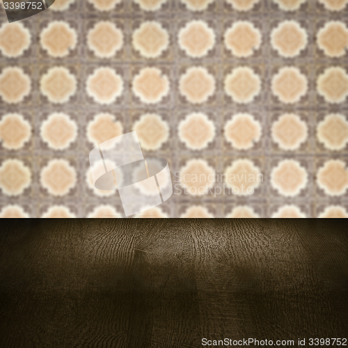 Image of Wood table top and blur vintage ceramic tile pattern wall
