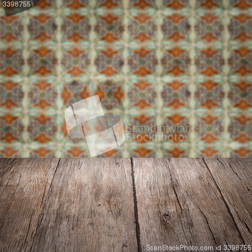 Image of Wood table top and blur vintage ceramic tile pattern wall