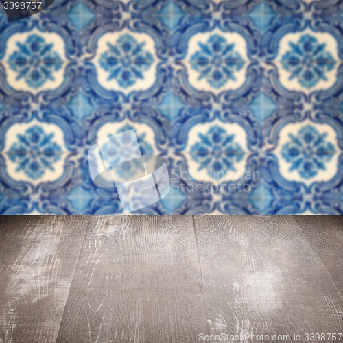 Image of Wood table top and blur vintage ceramic tile pattern wall