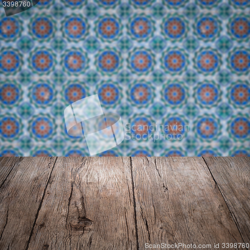 Image of Wood table top and blur vintage ceramic tile pattern wall