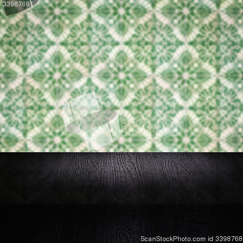 Image of Wood table top and blur vintage ceramic tile pattern wall