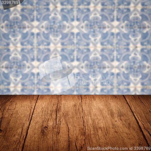 Image of Wood table top and blur vintage ceramic tile pattern wall