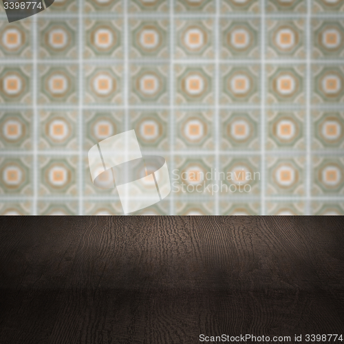 Image of Wood table top and blur vintage ceramic tile pattern wall