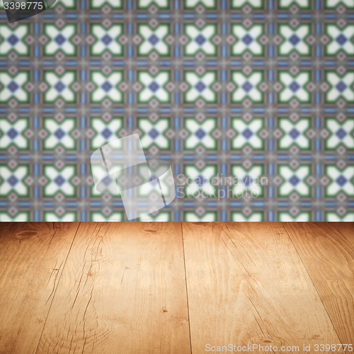 Image of Wood table top and blur vintage ceramic tile pattern wall
