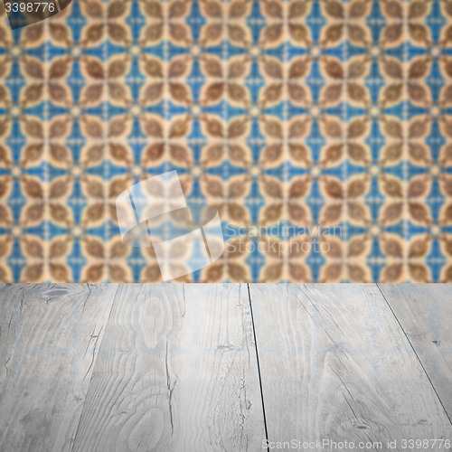 Image of Wood table top and blur vintage ceramic tile pattern wall