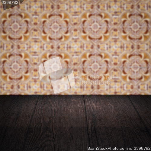 Image of Wood table top and blur vintage ceramic tile pattern wall